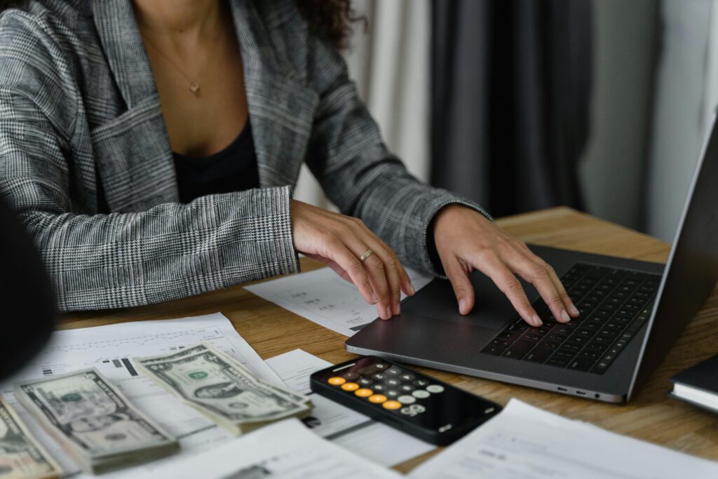 pexels photo 6693661 6693661 A businesswoman working on finance management with cash and calculator on desk.